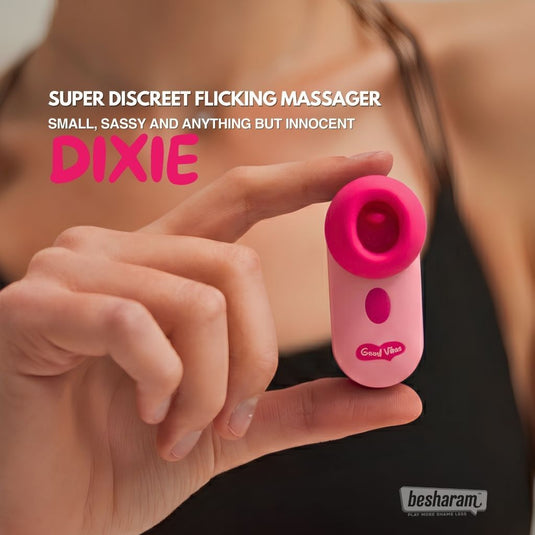 Dixie super discreet flicking massager held between fingers, highlighting compact size and playful pink design