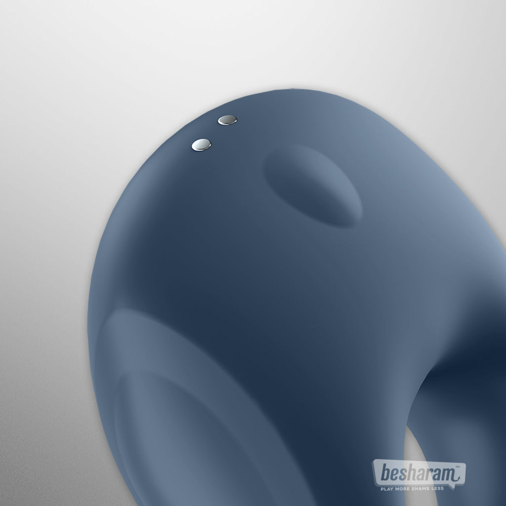 Close-up detail view of the Satisfyer Strong One app controlled cock ring showing charging points and control button