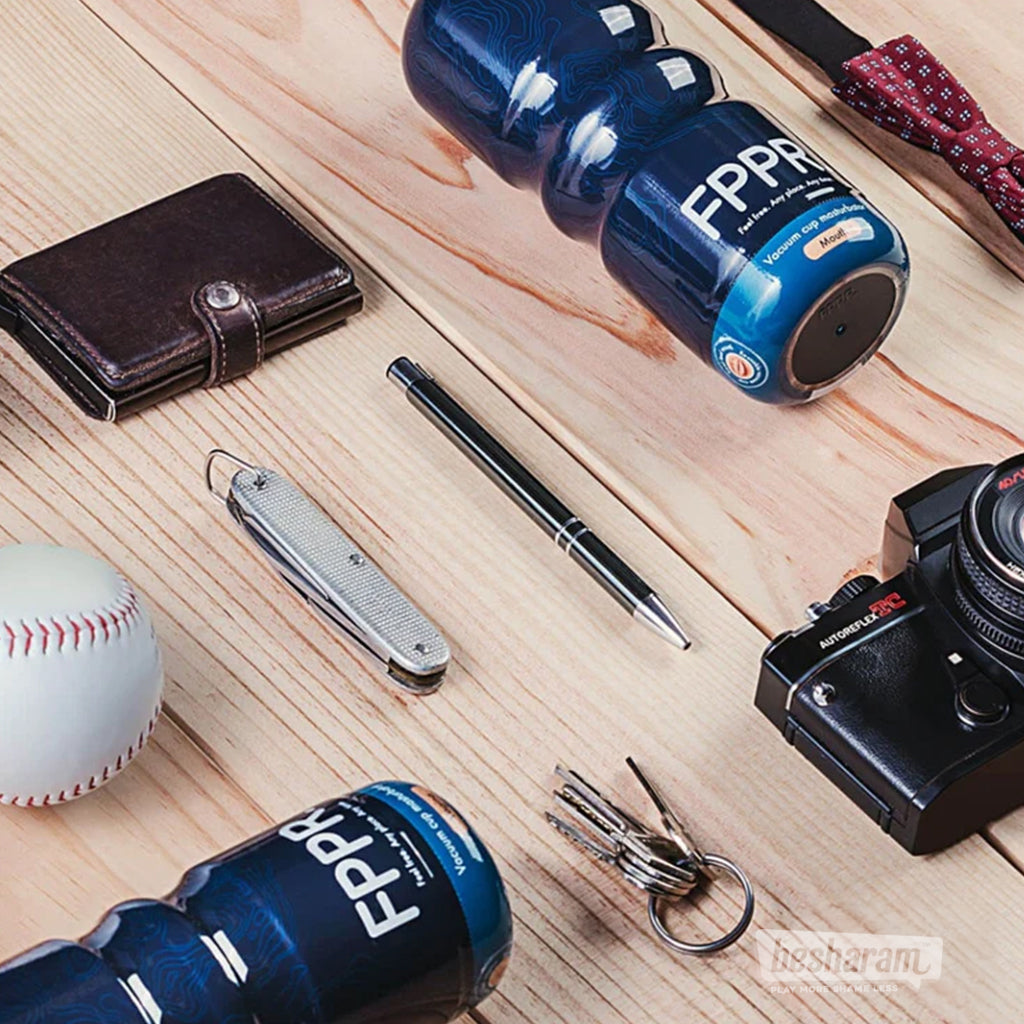 FPPR discreet masturbator placed on a wooden table beside wallet, pen, keys, and camera for lifestyle context
