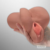 PDX Pick Your Pleasure realistic masturbator sleeve held in hand showing soft outer texture and lifelike opening