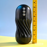 Playboy Solo Vibrating and Sucking Masturbator placed next to a ruler for size reference