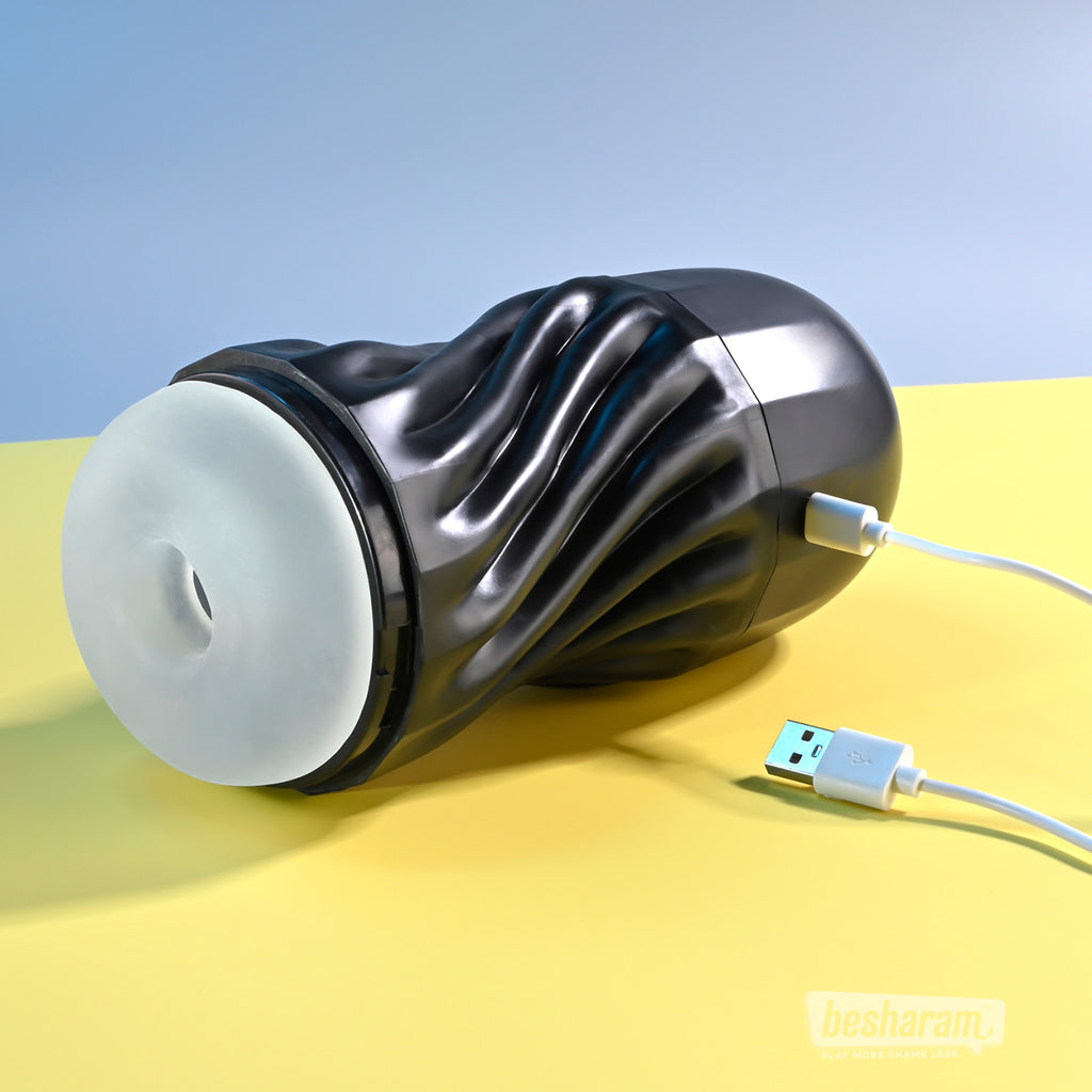 Playboy Solo Vibrating and Sucking Masturbator connected to USB charging cable