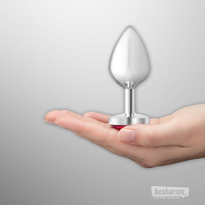 Viben Cheeky Charms silver heart butt plug displayed on an open palm showing smooth metal finish