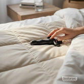 Anal Fantasy 9 prostate massager placed on bed with hand touching for lifestyle display