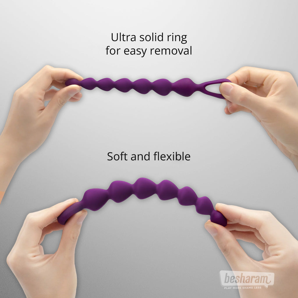 Purple silicone anal bead chain stretched by hands, soft and flexible anal beads with solid safety ring for easy removal