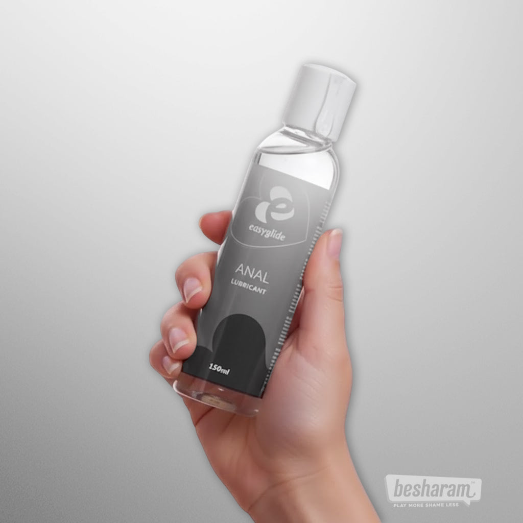 Hand holding EasyGlide anal lubricant 150ml bottle on clean light background for product showcase