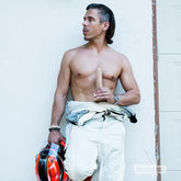 Realistic Mick Blue silicone dildo held in hand showing life size proportions and firm base design in lifestyle setting