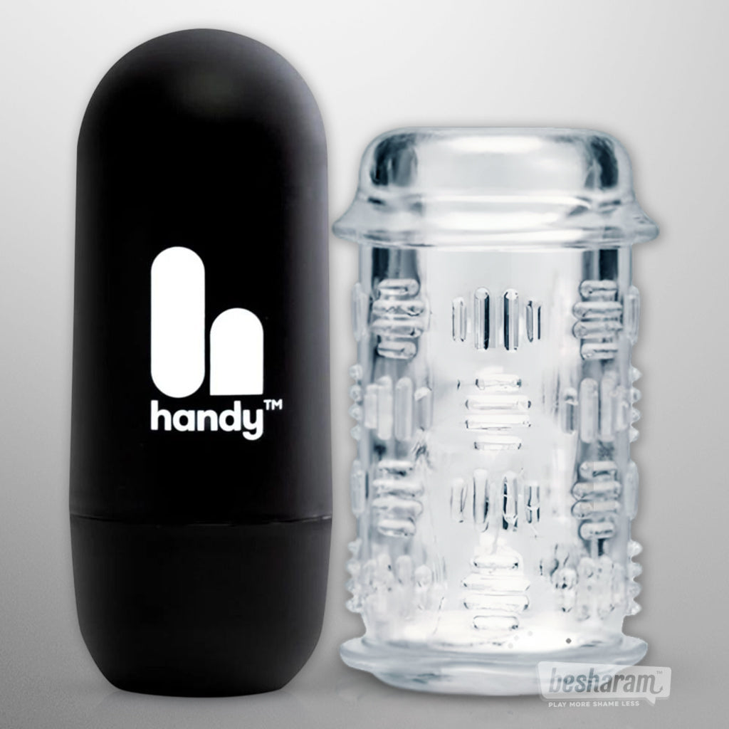 Black Handy Flow automatic male masturbator next to a clear textured silicone sleeve on a light background