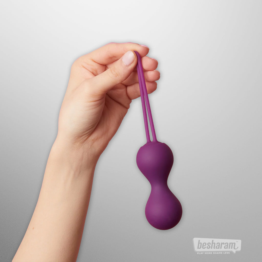 Purple silicone kegel balls held by hand, double string design for easy removal, vaginal exercise balls for pelvic floor strengthening
