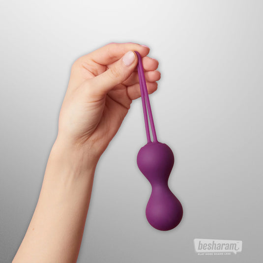 Purple silicone kegel balls held by hand, double string design for easy removal, vaginal exercise balls for pelvic floor strengthening