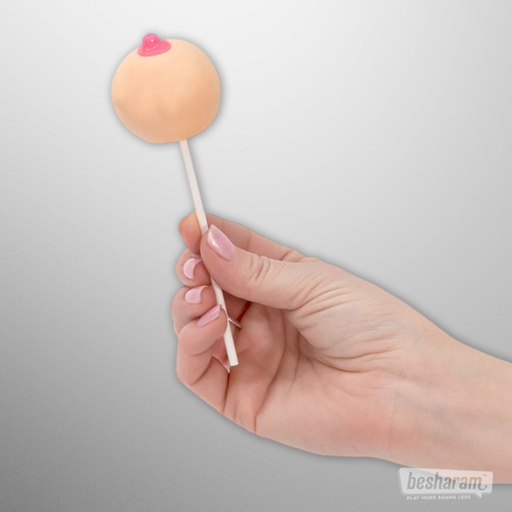 Hand holding Lil’ Boobie Pop novelty lollipop with strawberry-flavored, breast-shaped candy.