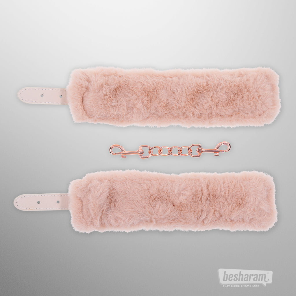 Peaches n Creame faux fur handcuffs in soft blush pink with rose gold chain connector front view