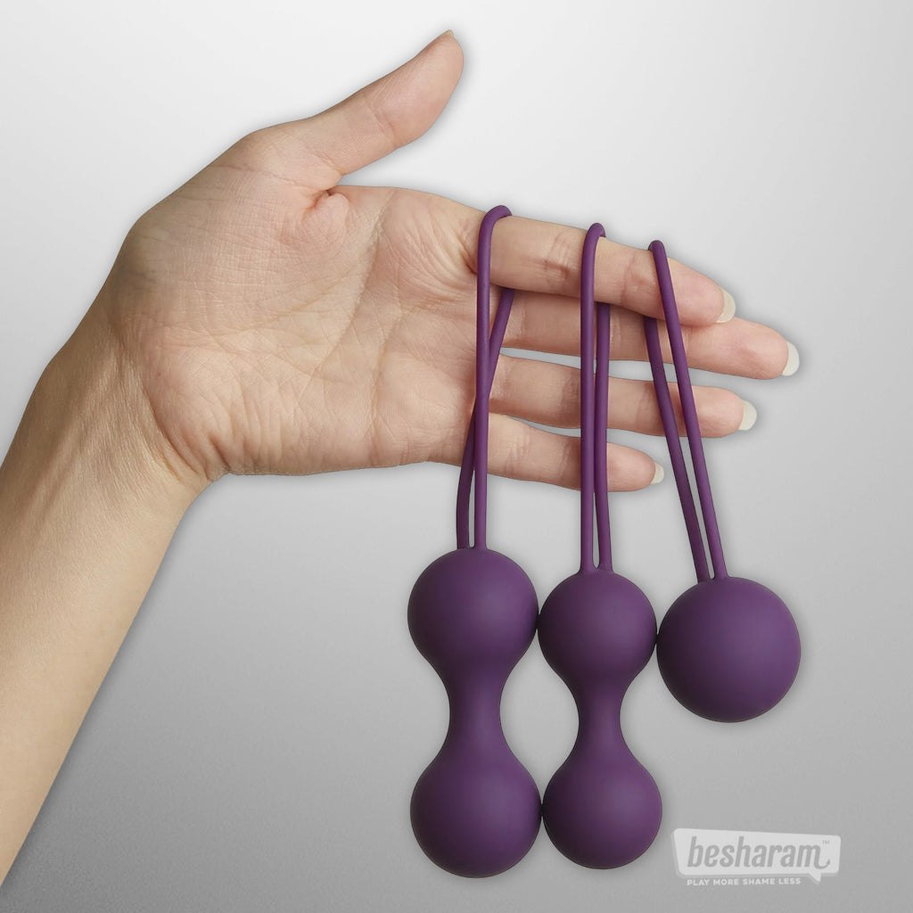 Hand holding the Per’Fit Kegel balls set to show size and flexible retrieval loops.