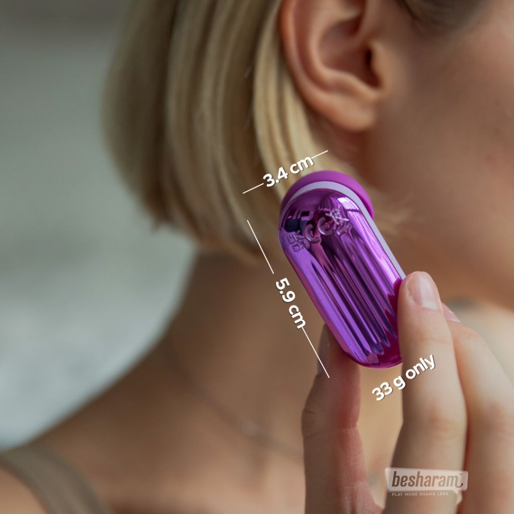 Pixie suction massager held near ear showing compact size, lightweight body, and dimensions for discreet portability