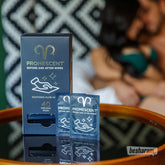 Promescent Before and After Wipes box with two sachets on a table, with a couple blurred in the background.