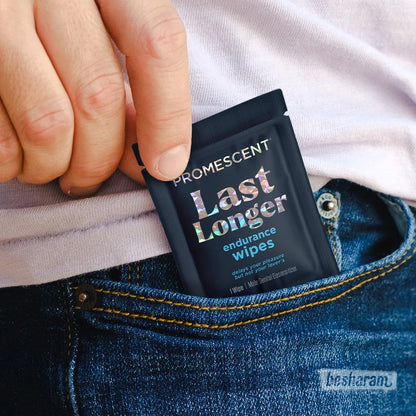 Hand placing a Promescent Last Longer endurance wipes sachet into a jeans pocket.
