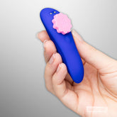 ROMP Party panty vibrator held in hand to show compact size and curved shape
