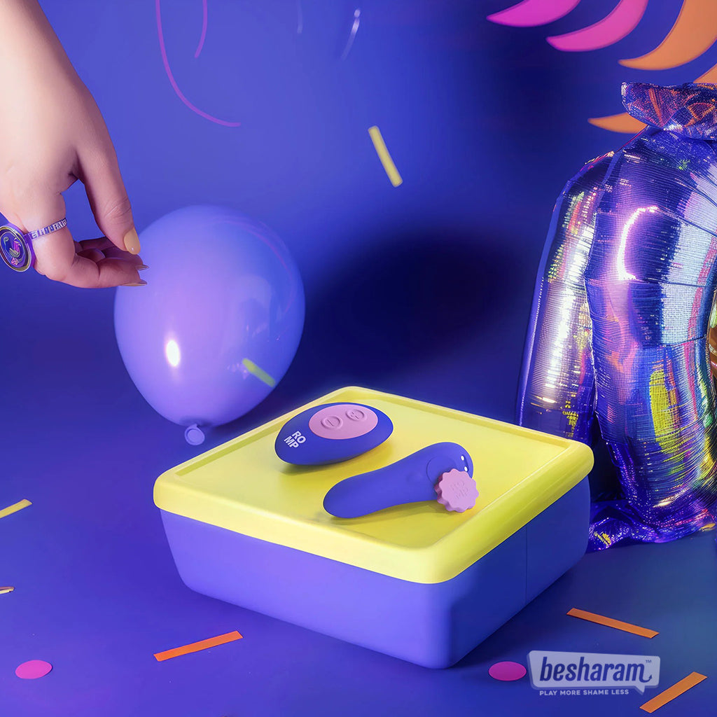 ROMP Party panty vibrator and remote displayed in colorful party themed lifestyle setup
