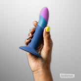 Hand holding ROMP Piccolo pegging dildo showing size grip and curved tip