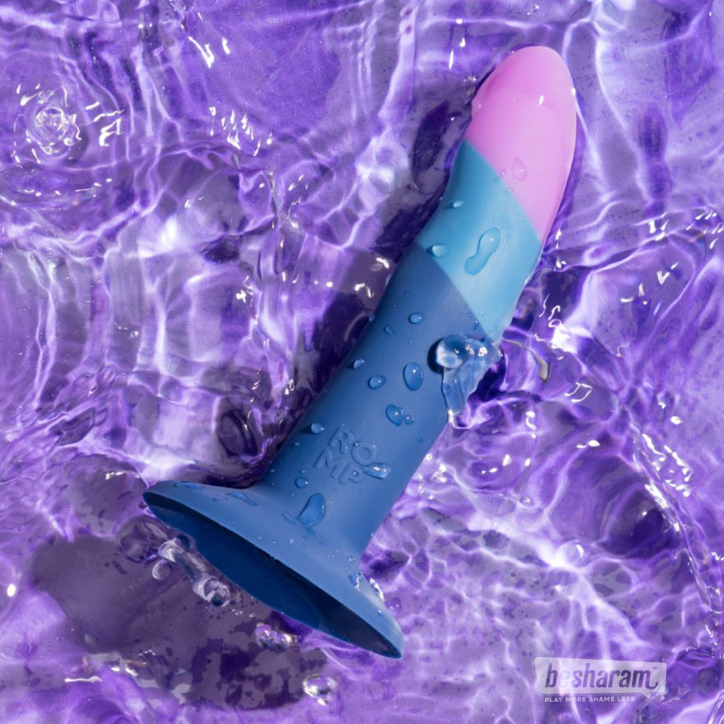 ROMP Piccolo pegging dildo in blue and purple placed in water showing waterproof silicone design