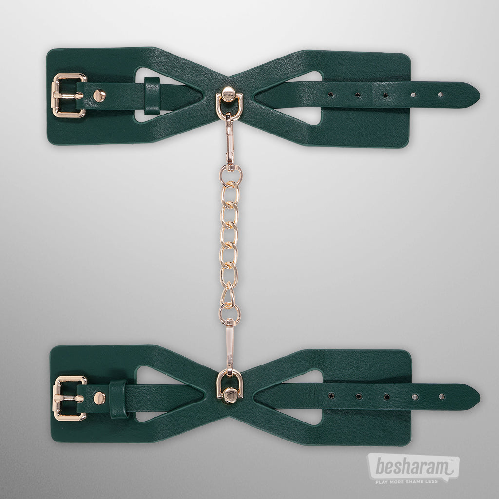 Indica cutout cuffs laid flat showing adjustable straps and chain connector