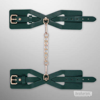 Indica cutout cuffs laid flat showing adjustable straps and chain connector