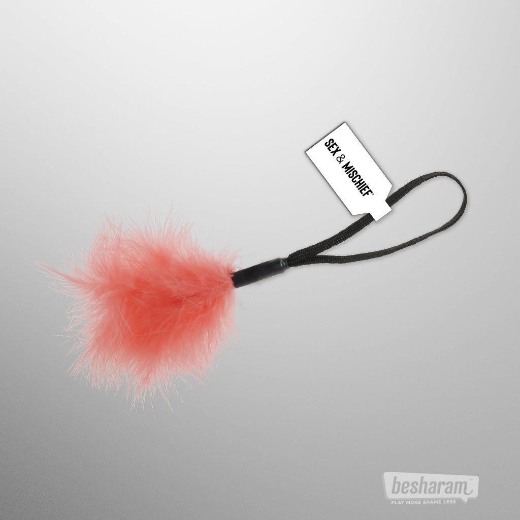 Peach feather tickler with wrist loop by Sex &amp; Mischief for light teasing and foreplay