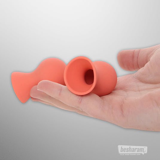 Sex Mischief silicone nipple suckers shown in hand with suction opening visible