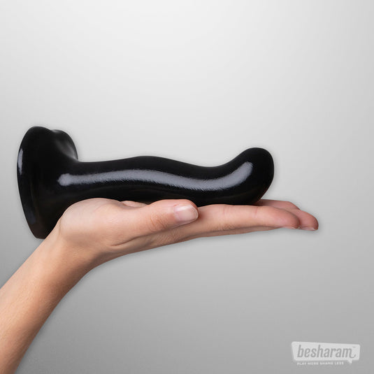 Curved black strap-on-me P and G spot dildo size S placed on a hand showing product size.