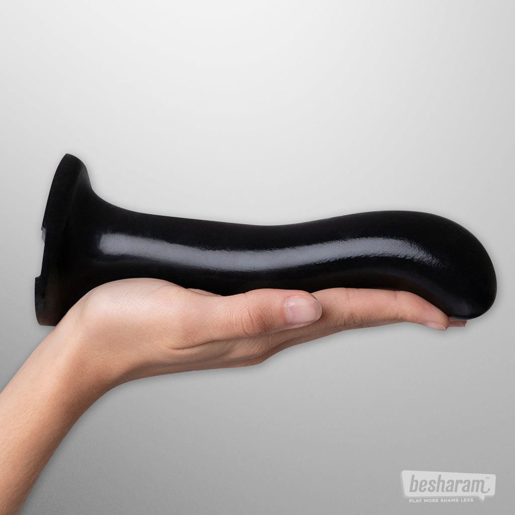 Large curved black P and G spot dildo size XL shown on a hand for scale.