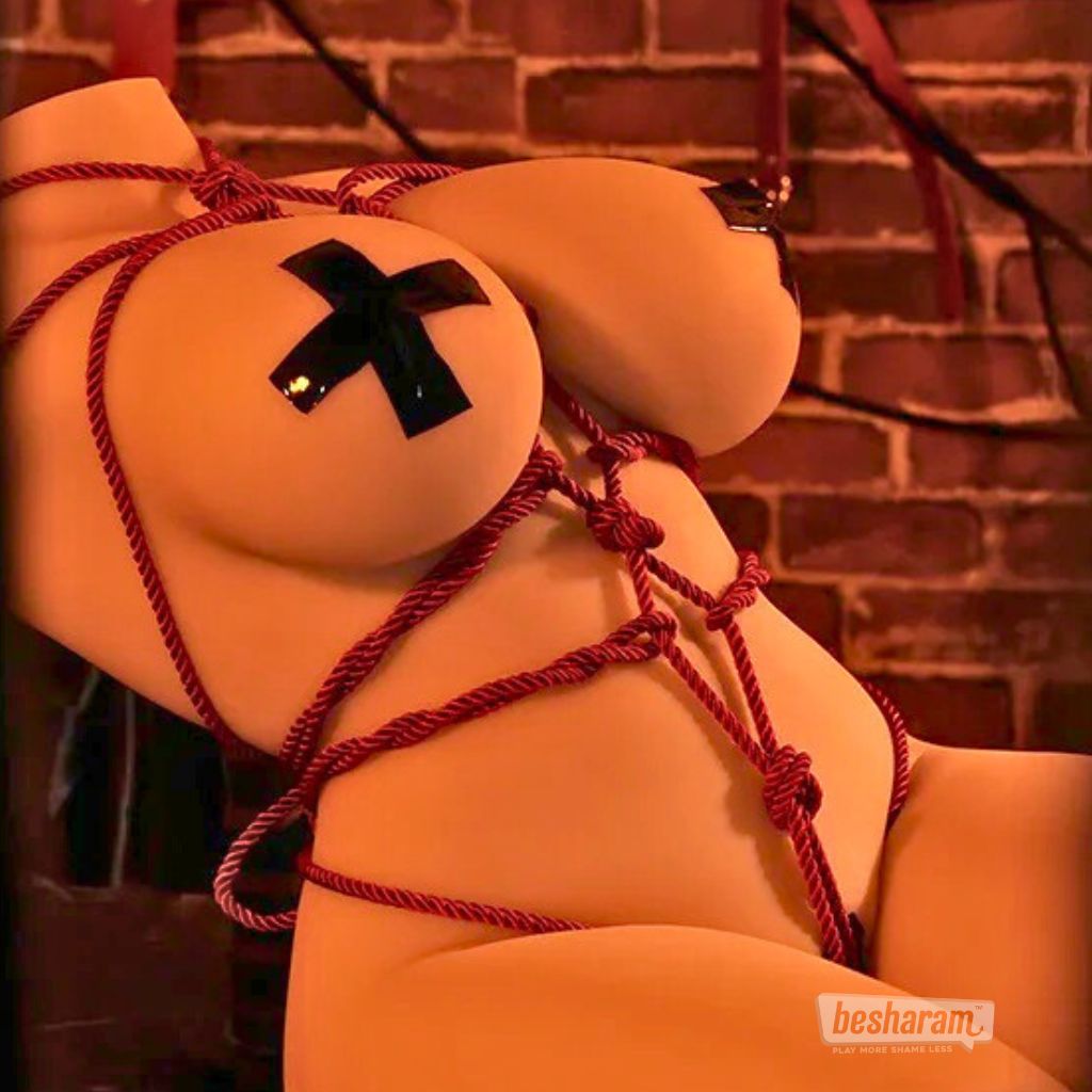 Torso doll displayed in artistic rope pattern styling with a warm studio background.